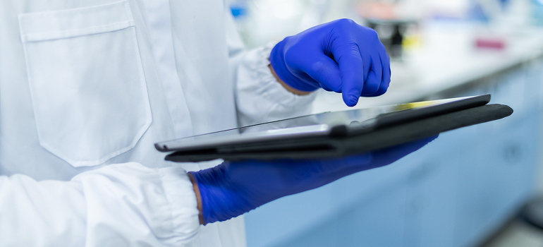 Image of lab technician using a tablet