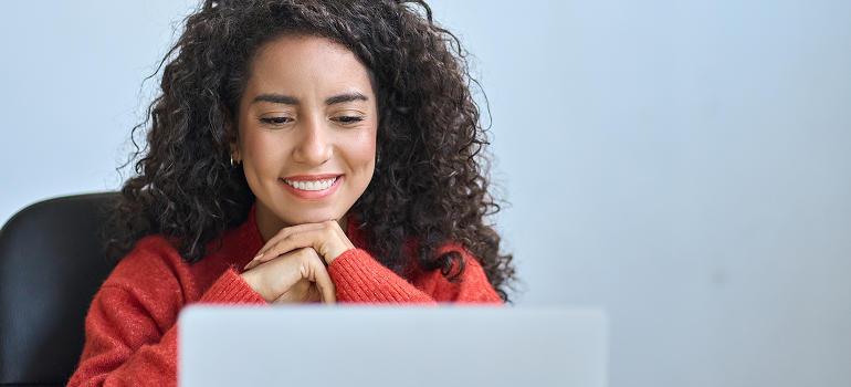 image of woman smiling at her computer