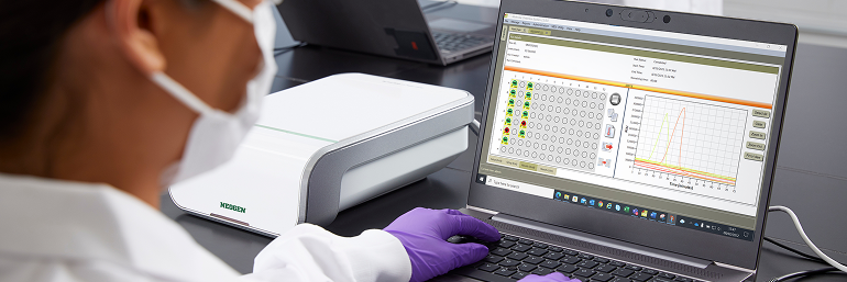 Lab technician checks real-time LAMP pathogen test results on Neogen Molecular Detection System software.