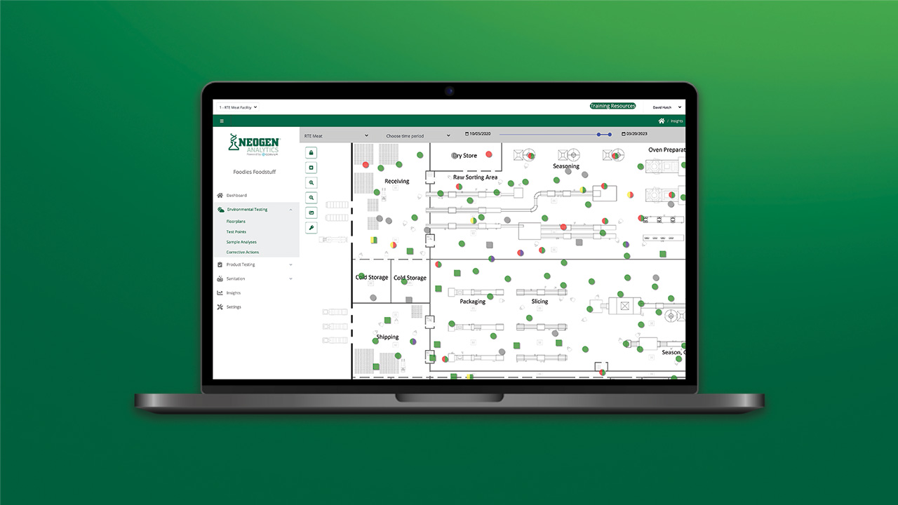 Laptop showing Neogen Analytics dashboard with environmental monitoring data and facility mapping visualization.