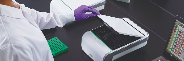 Lab technician runs pathogen tests on a compact Neogen Molecular Detection Instrument using LAMP.
