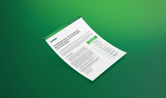 Document mockup titled “Word Soup: Components That Ensure Food Safety in the Food Supply,” featuring green accents, floating on a solid green background, representing food safety compliance and supply chain quality control.