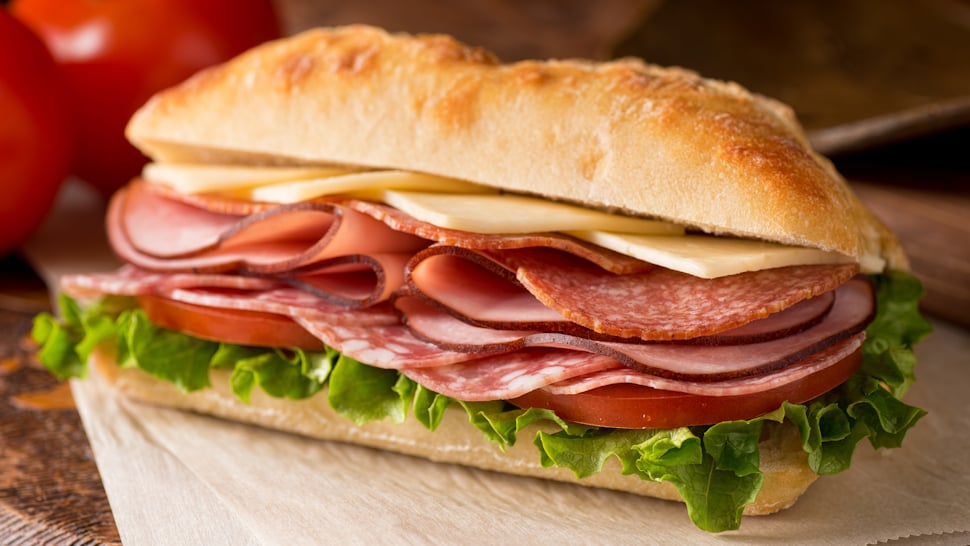 Deli meat, cheese, tomato, and lettuce hoagie