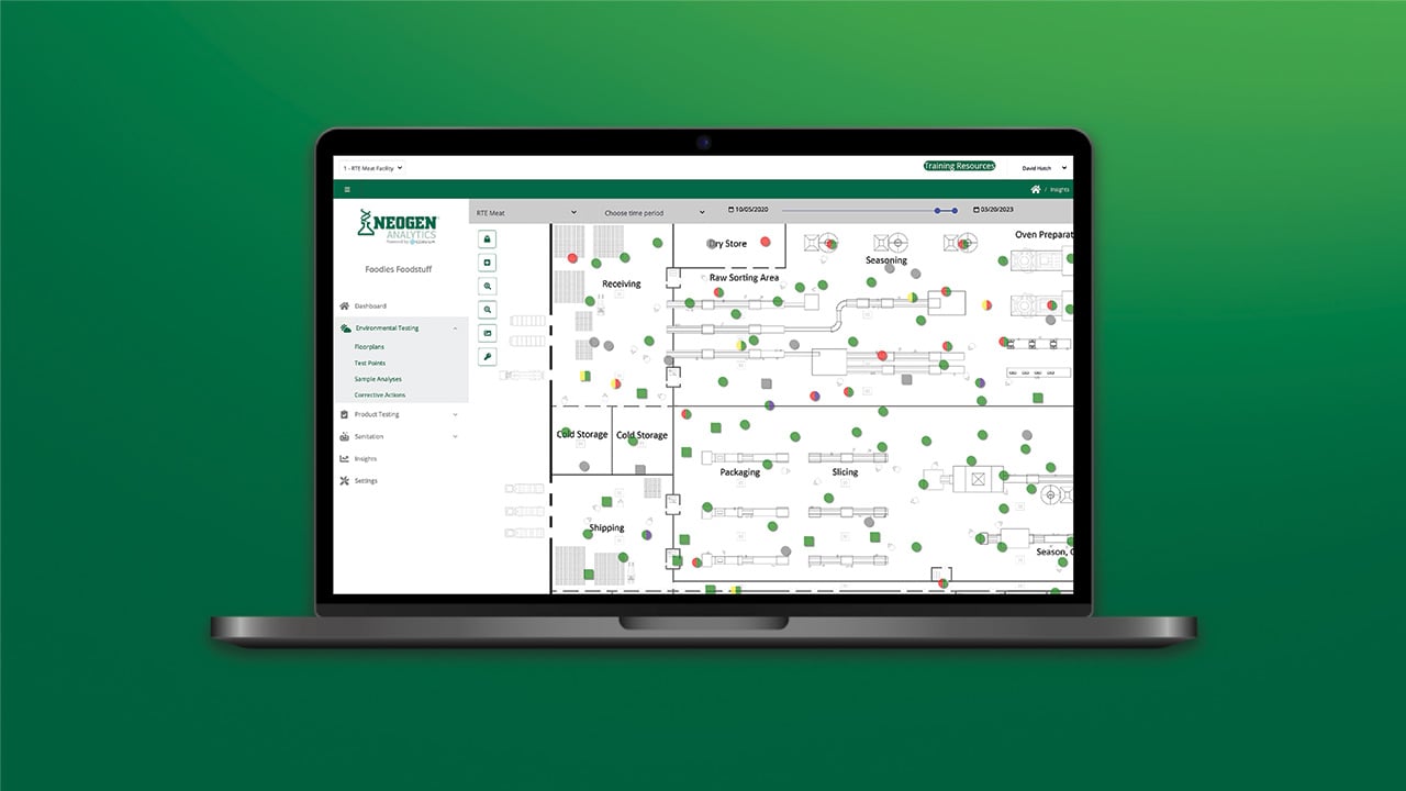 Laptop showing Neogen Analytics dashboard with environmental monitoring data and facility mapping visualization.