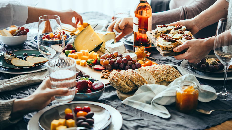 Group enjoy wine, cheese and other products after food and beverage quality testing in a food processing environment.