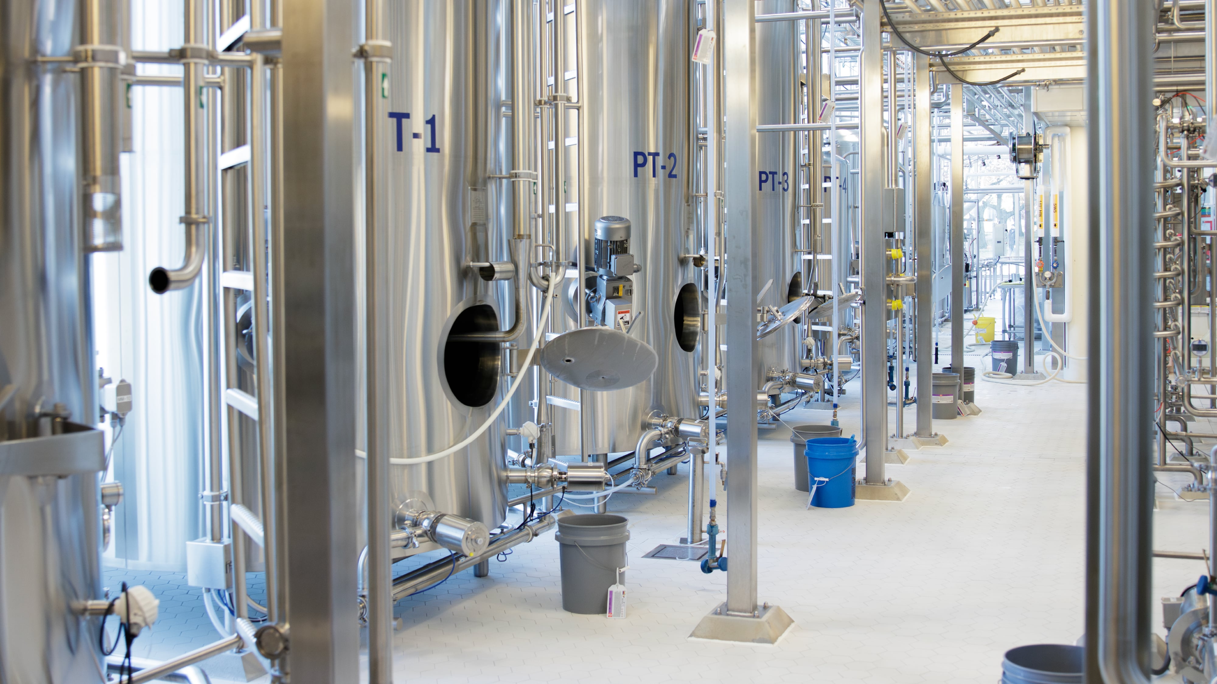 Close-up of stainless steel vats in a dairy ice cream processing plan