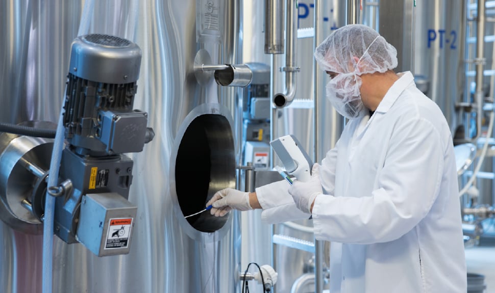 Food safety technician swabbing a dairy processing vat using the Neogen® Clean-Trace® ATP Testing System