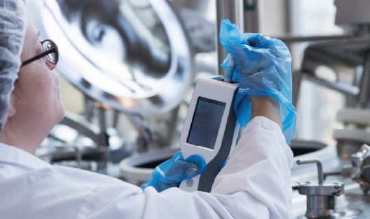 Food safety tech reviewing ATP test results.