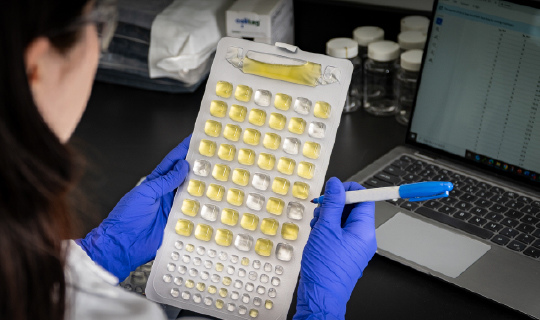 Person in lab working with Colitag MPN Tray