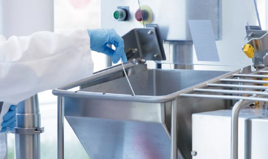 Food safety technician swabbing mixer