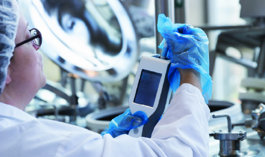 Food safety tech reviewing ATP test results.