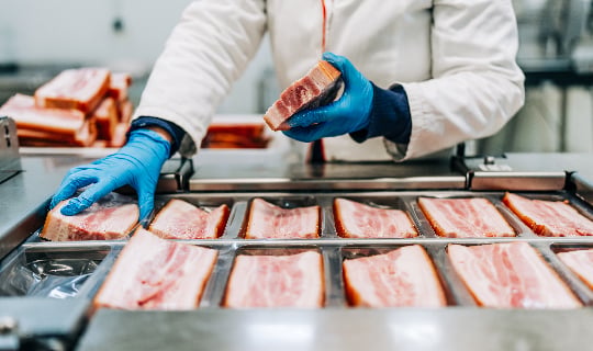 Image of pork chops being processed